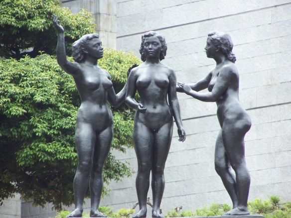 Three nude women sitting around chatting, as happens all the time... in the dreams of men. 