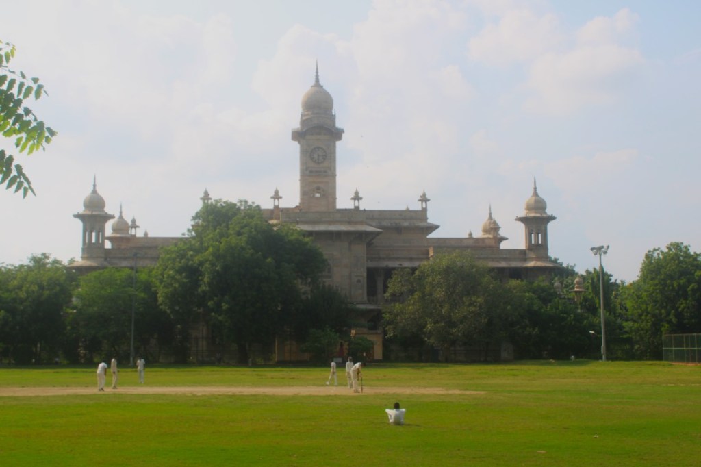 College students playing cricket on the field in front of Maharani Laxmi Bai Arts and Commerce College in Gwalior, Madhya Pradesh, India.