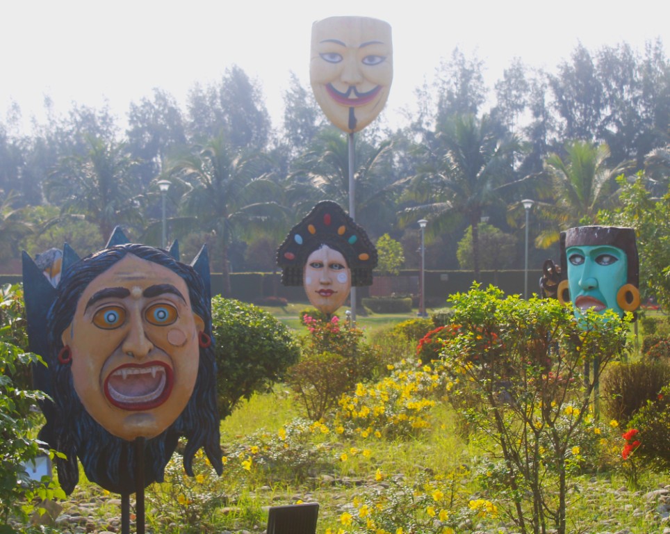 An assortment of masks, including Guy Fawkes and Dracula, in the Mask Garden of Kolkata's Eco Park.