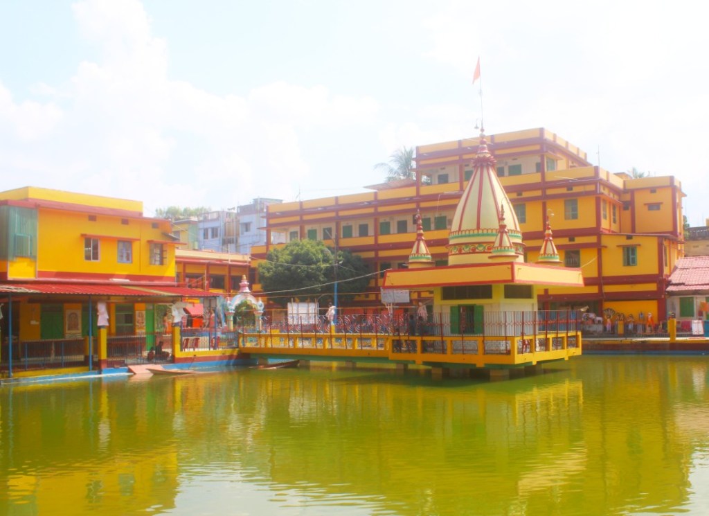 Stepwell and shrine on the grounds of Sri Jagannath Temple in Agartala, Tripura, India. And it was all Yellow.