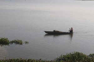 A fisherman paddling a canoe on the Rudrasagar Lake (a.k.a. Twijilikma) in Melaghar, Tripura, India. 