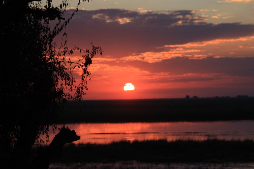 Photograph of a sunset taken from the Botswanan bank of the Chobe River in the Chobe National Park. 