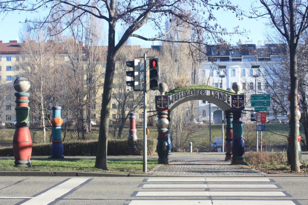A photograph of a street crossing of Weissgerber Lande Street to the Hundertwasser Promenade in Vienna, Austria.