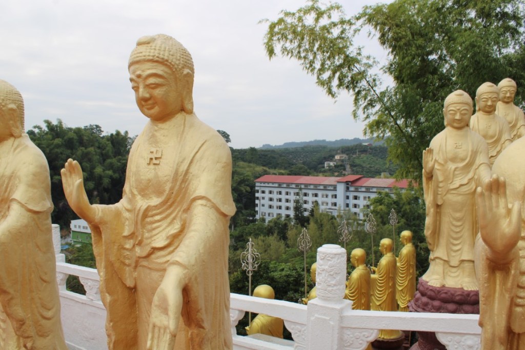 Photograph of gold Buddhas arranged by staircases at Fo Guang Shan, near Kaohsiung, Taiwan.