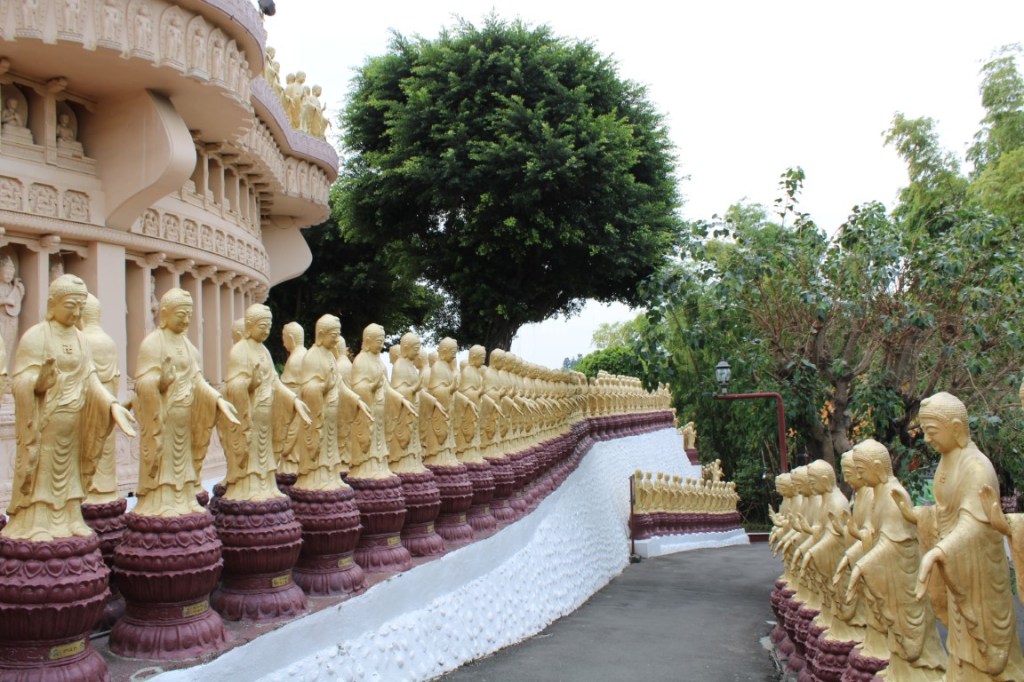 Photograph of rows of gold Buddhas taken at Fo Guang Shan, near Kaohsiung, Taiwan.