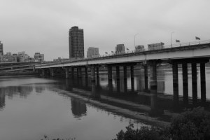 Monochrome photograph of a bridge taken in Taipei, Taiwan on a cloudy day. 
