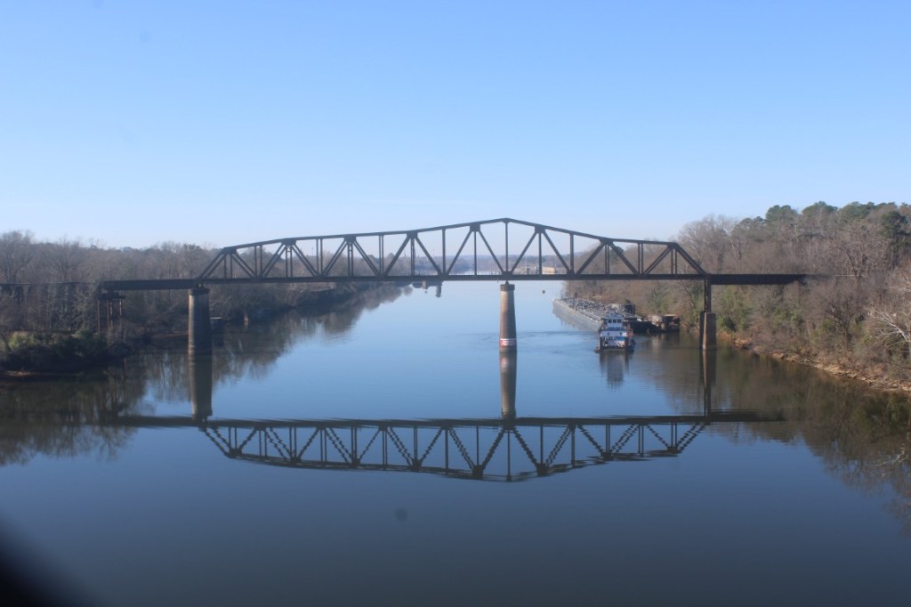Photograph of the railway bridge over the Black Warrior River from the Hugh R. Thomas Bridge in Tuscaloosa, Alabama.