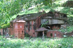 Photograph of an overgrown scale model of Dutch Square. The model is located on Bukit Cina (Chinese Hill.)