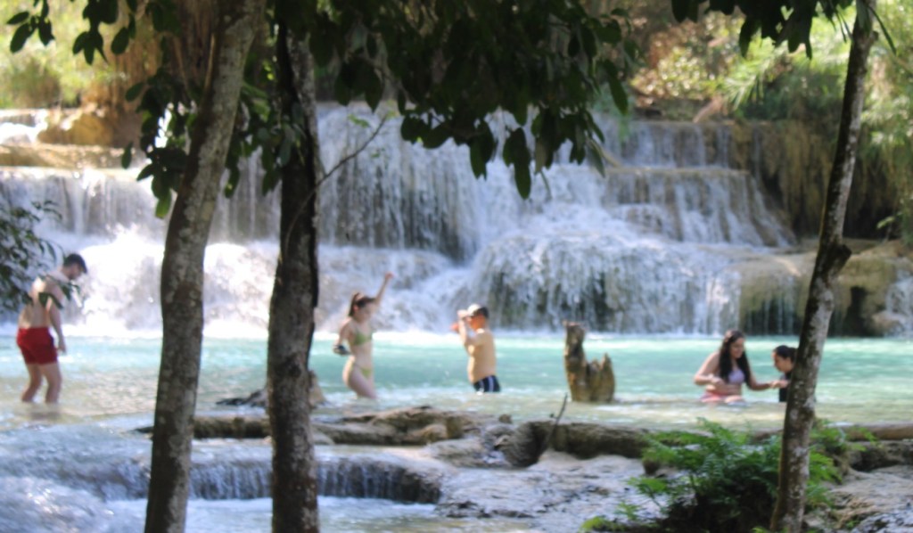 Photograph of bathers at Kuang Si waterfall in Ban Long, Laos.