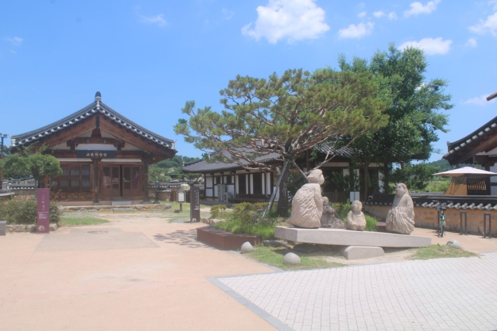 Photograph featuring classic Korean architecture and a seesaw statue. Taken in Gyeongju, South Korea.