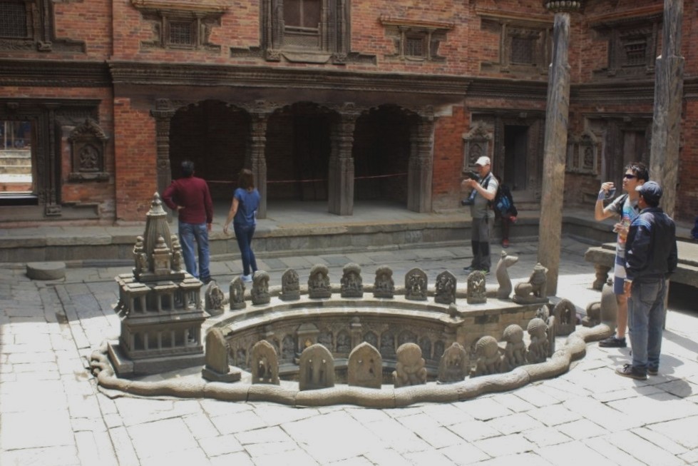 Photograph of an ornate well in a courtyard at Mul Chowk in Patan's (Lalitpur's) Durbar Square. Taken from the side. 