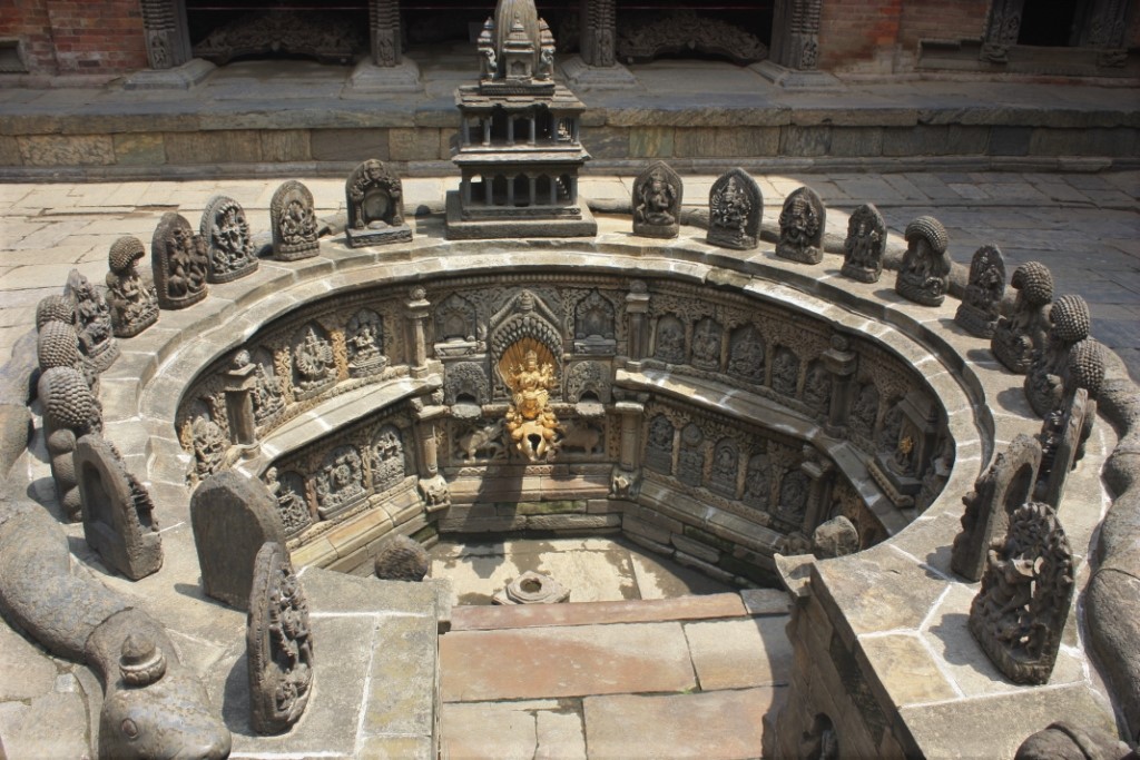 Photograph of an ornate well in a courtyard at Mul Chowk in Patan's (Lalitpur's) Durbar Square. Taken from the front.