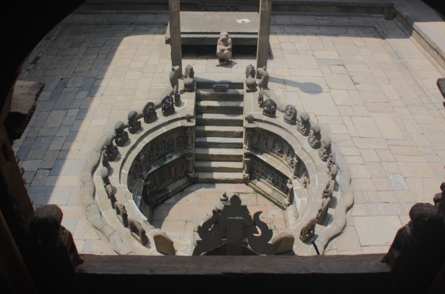 Photograph of an ornate well in a courtyard at Mul Chowk in Patan's (Lalitpur's) Durbar Square. Taken from above.