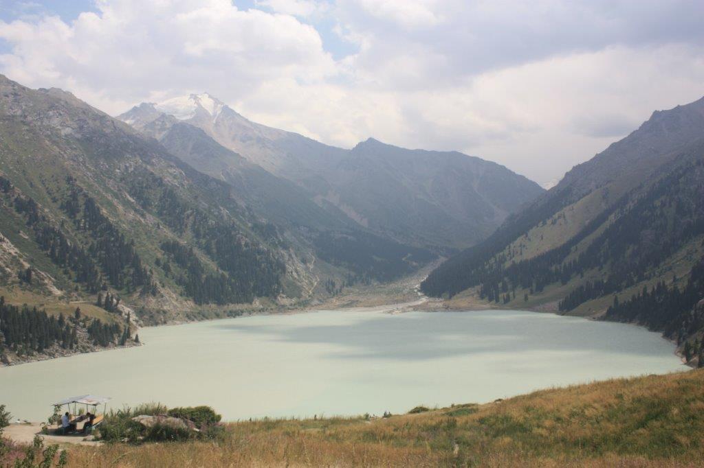 Photograph of Big Almaty Lake (Үлкен Алматы көлі) near Almaty, Kazakhstan. The lakes color changes over the course of the year. Here it is a sediment loaded gray color. 