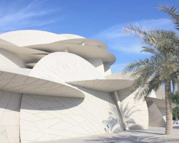 Photograph of the National Museum of Qatar with palm tree -- taken in Doha.