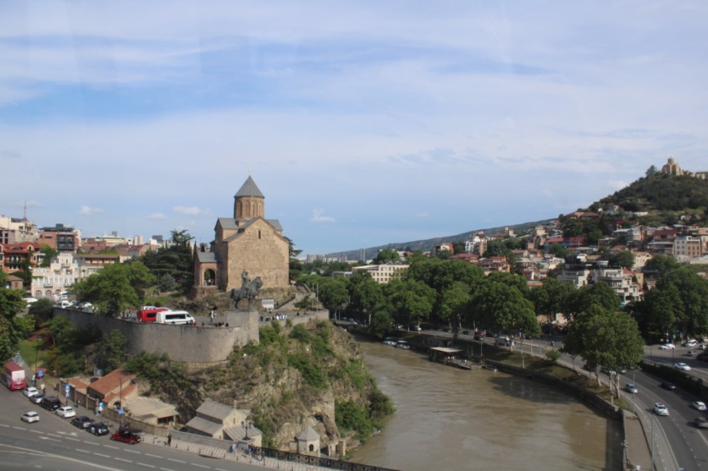Photograph taken from the Tbilisi Cable Car directly over the Kura River, looking towards the Metekhi Church of the Nativity.