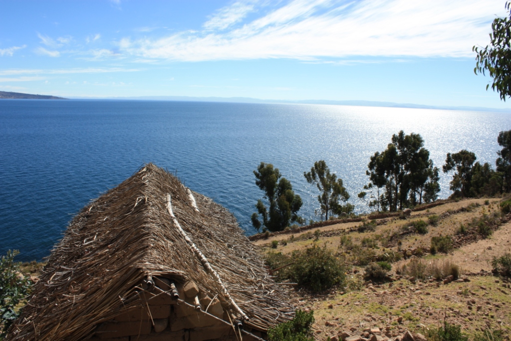 Photograph taken from Amantani Island in Lake Titicaca. Taken from the hilltop over the roof of a thatched hut.