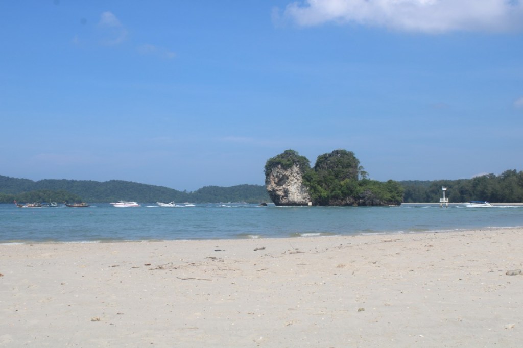 Photograph of Noparat Thara Beach and the rocky islands nearby taken at Ao Nang, Thailand.