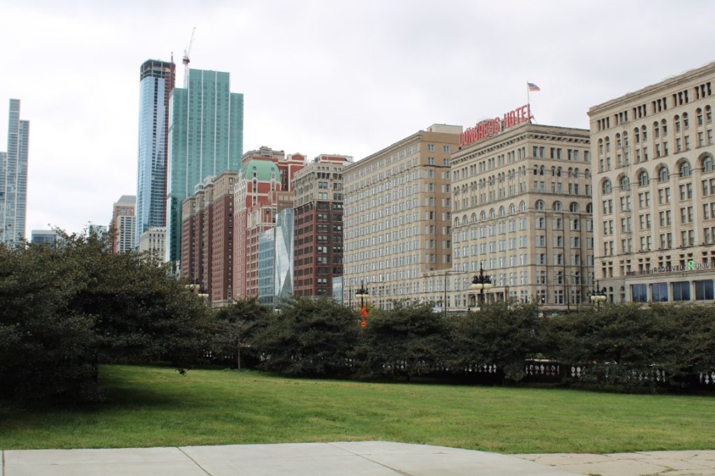 Photograph of South Michigan Ave buildings, centered on the Congress Hotel, taken from Grant Park in Chicago.