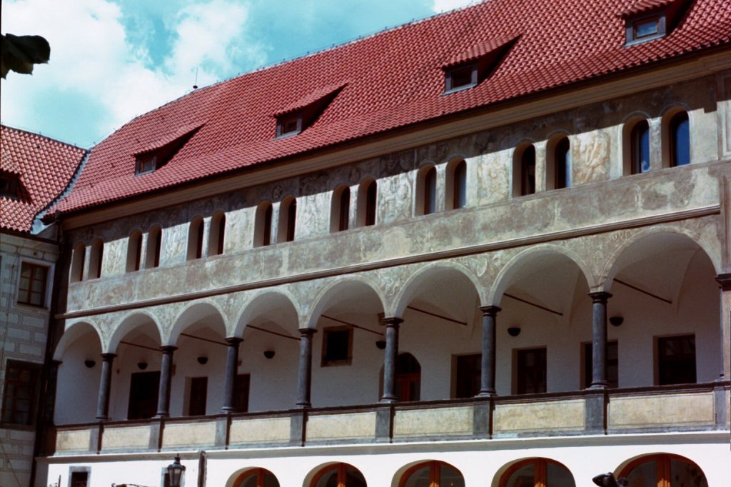 Photograph of a building in Prague, Czech Republic that features arches, columns, and dormers.