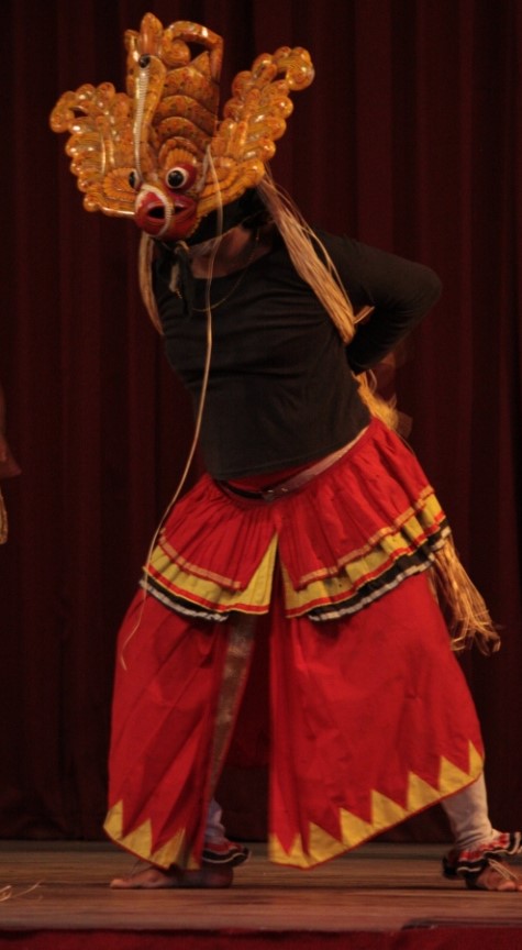Photograph of a dancer in a Garuda mask at the Kandyan Cultural Centre in Kandy.