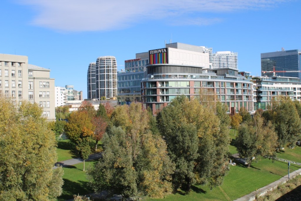 Photograph of Eurovea buildings and park facing the Danube River in Bratislava, Slovakia. Taken from the Old Bridge (i.e. Starý most.)