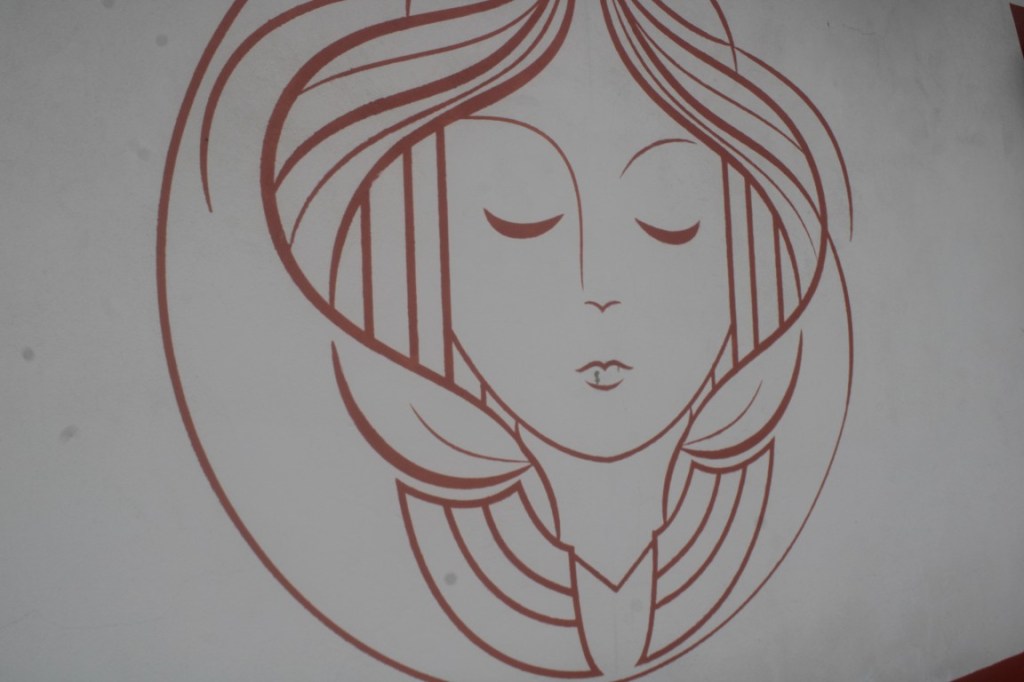 Drawing of a lady's face on a restaurant in Zipaquira.
