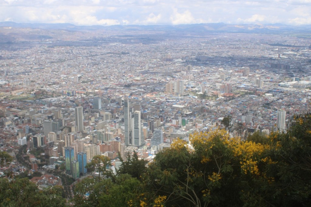 Photograph of Bogota from Monserrate with yellow flowering trees. 