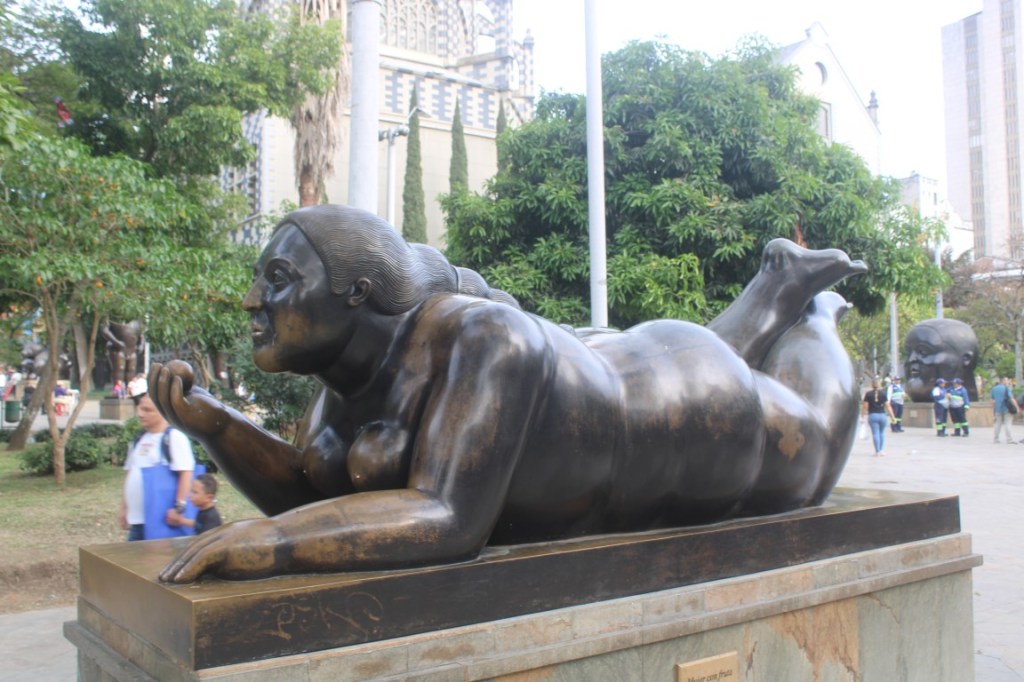 Photograph of a prone woman in Botero Plaza in Medellin, Colombia.