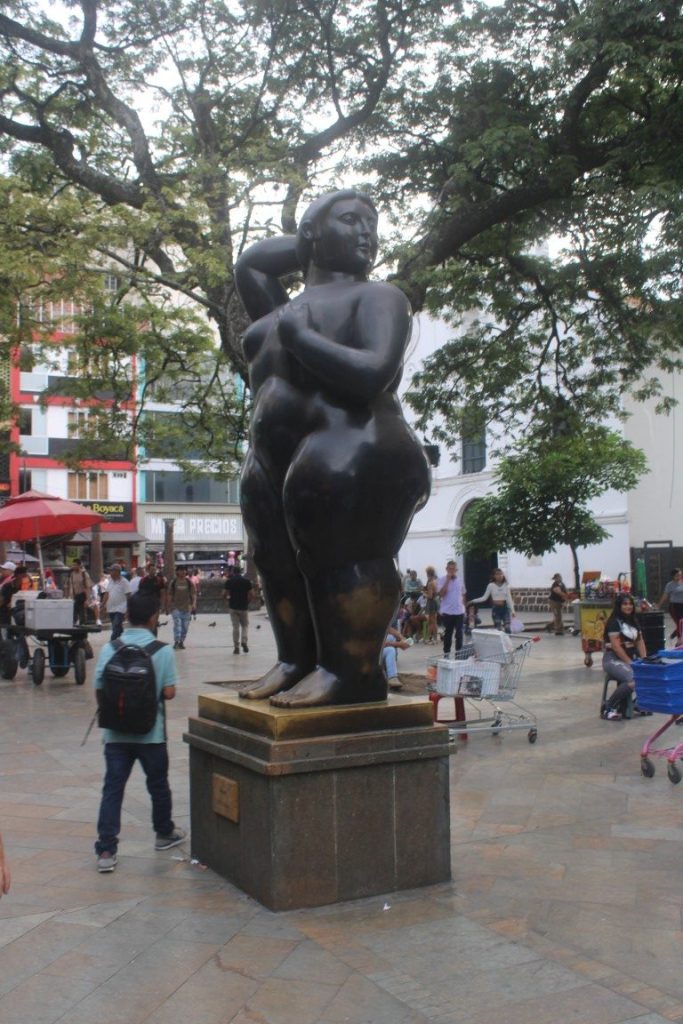Photograph of a standing woman taken in Botero Plaza, Medellin.
