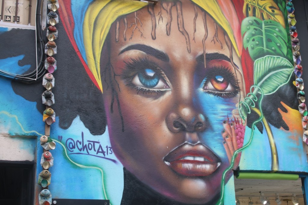 Photograph of a pretty girl with heterochromia in Medellin's Comuna 13. The neighborhood, once famous for its crime and hidden guerrillas is now famous for its art.