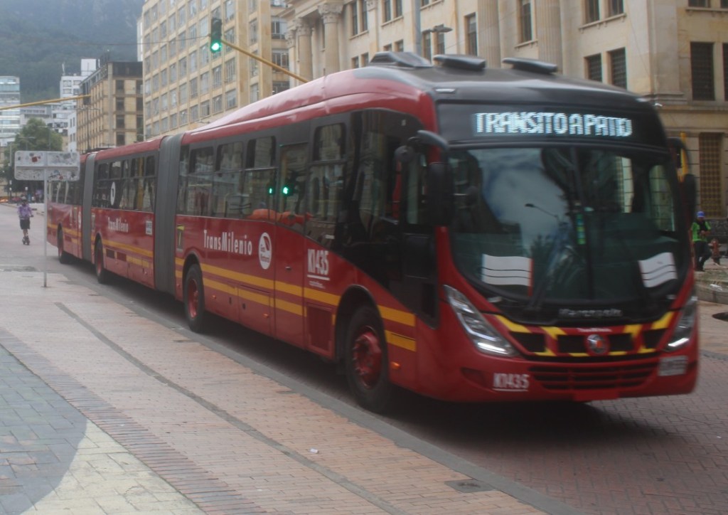 Closeup frontal photograph of one of Bogota's 3-sectional Buses.