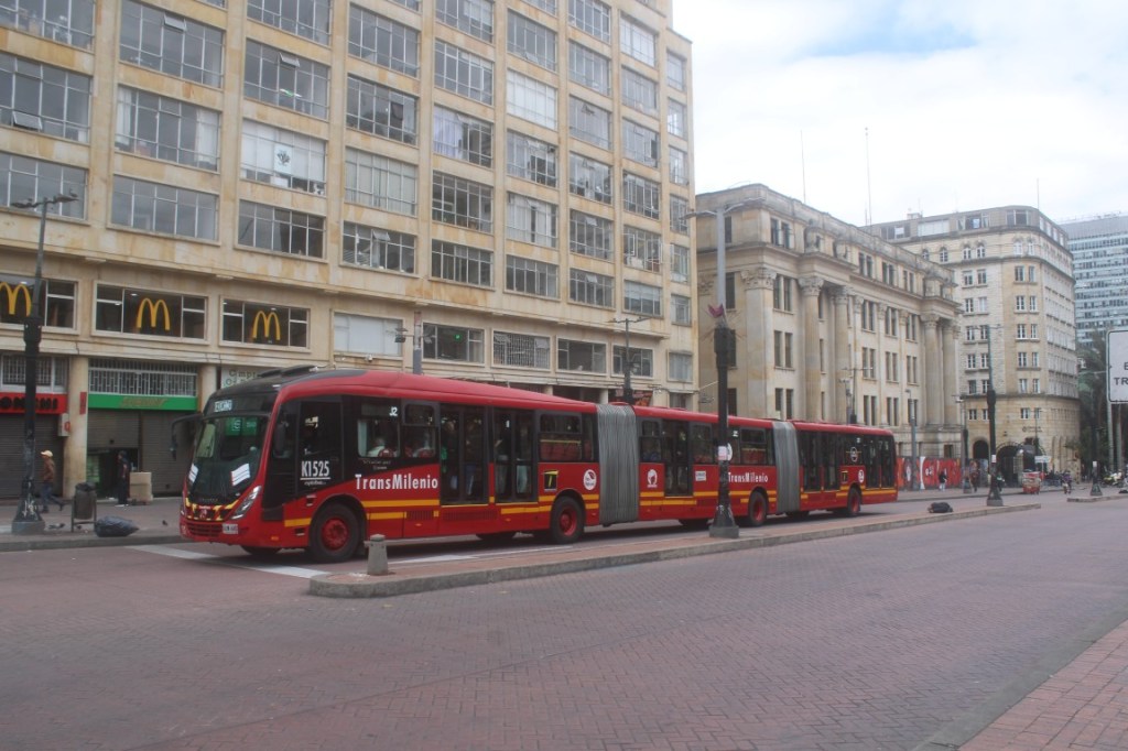 Side view photograph of one of Bogota's 3-sectional buses.