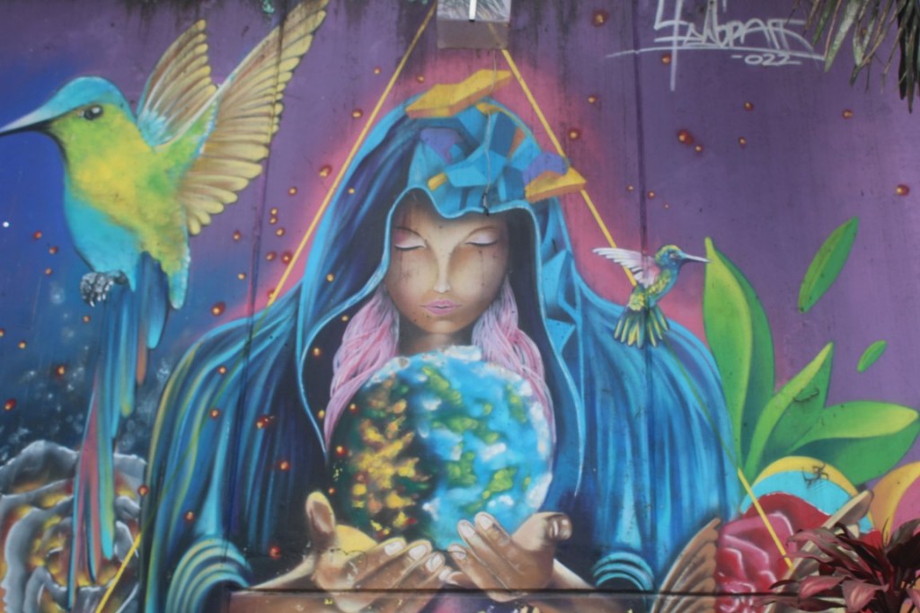Photograph of a colorful wall mural in Comuna 13.
