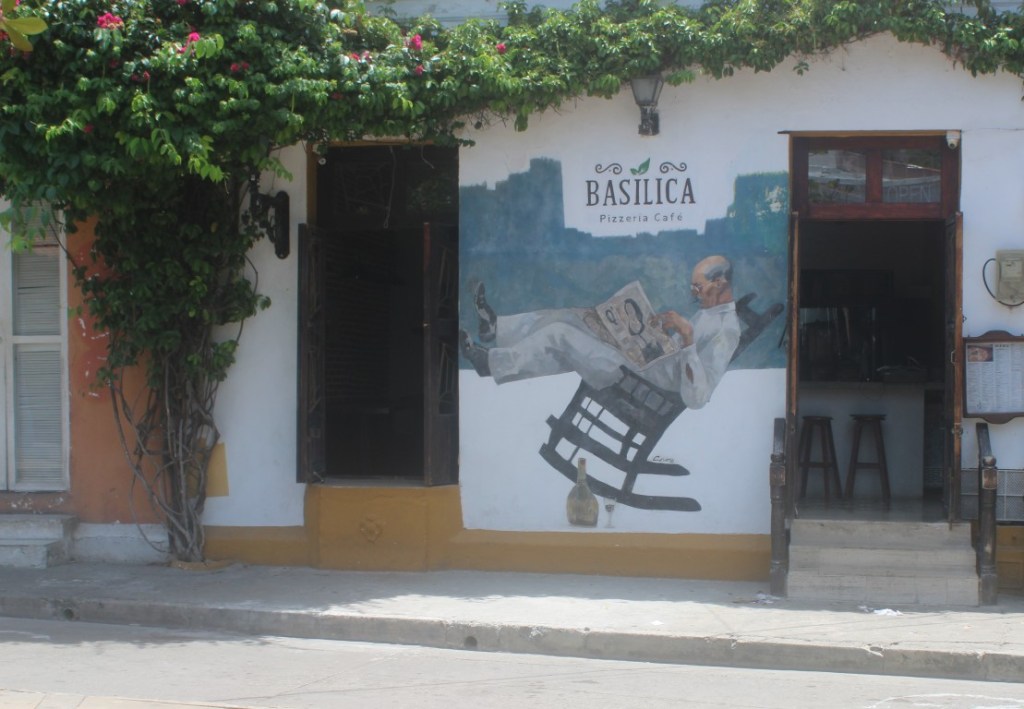 Photograph of a wall mural of a man in a rocking chair, taken in Barrio Getsemaní of Cartagena, Colombia.